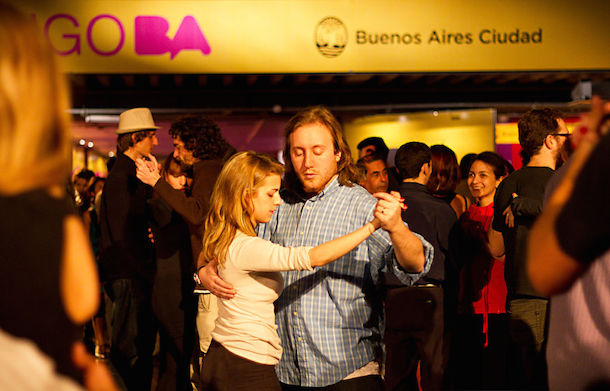 2 dancers in a crowd at a milonga during Tango BA