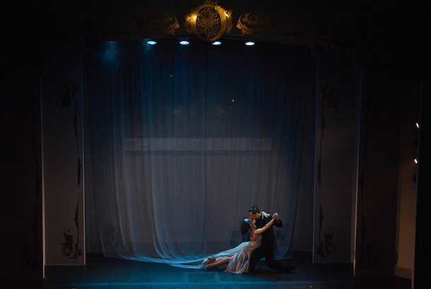 The dancer's dress is a continuation of the curtain